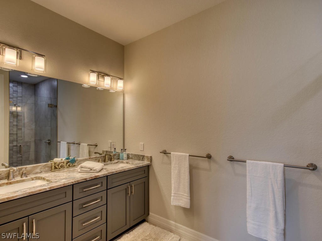 12523 River Road Fort Myers, FL 33905 - Photo 17 of 24 a bathroom with a double vanity sink and a mirror