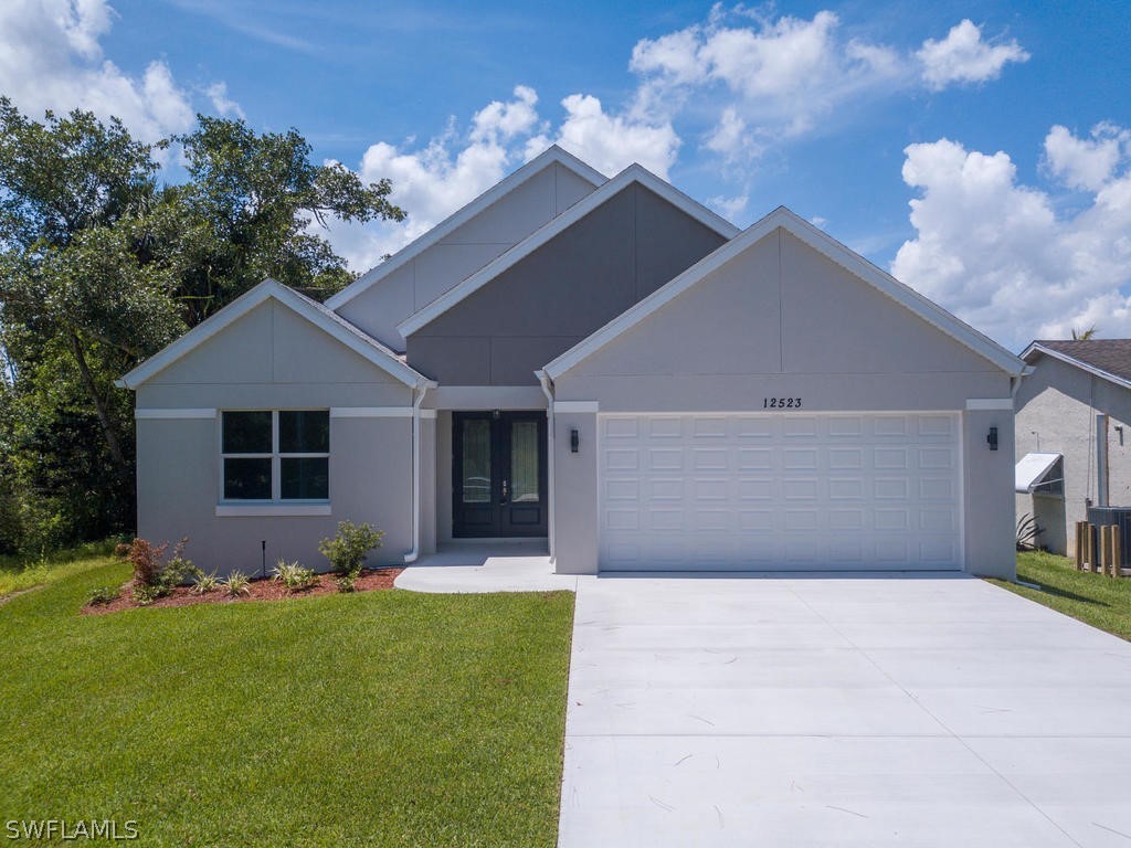 12523 River Road Fort Myers, FL 33905 - Photo 2 of 24 a front view of house with yard and green space