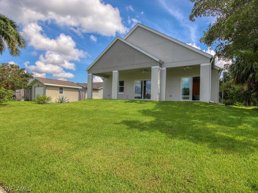 12523 River Road Fort Myers, FL 33905 - Photo 3 of 24 a front view of a house with a yard