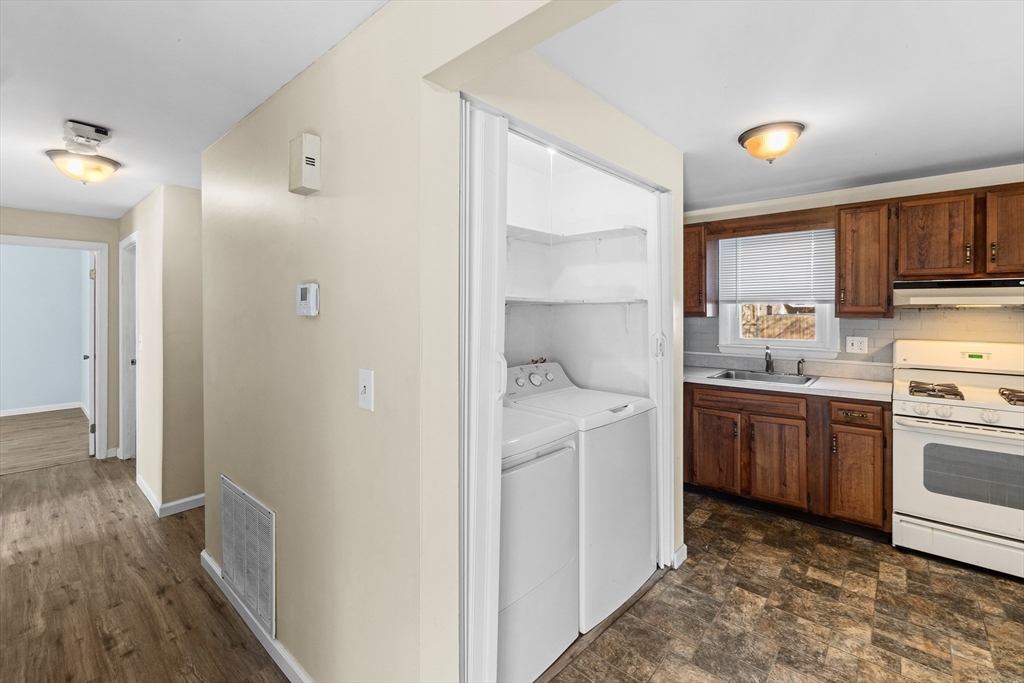 12 Parker Drive Wareham, MA 02571 - Photo 11 of 32 a kitchen with a refrigerator sink and cabinets