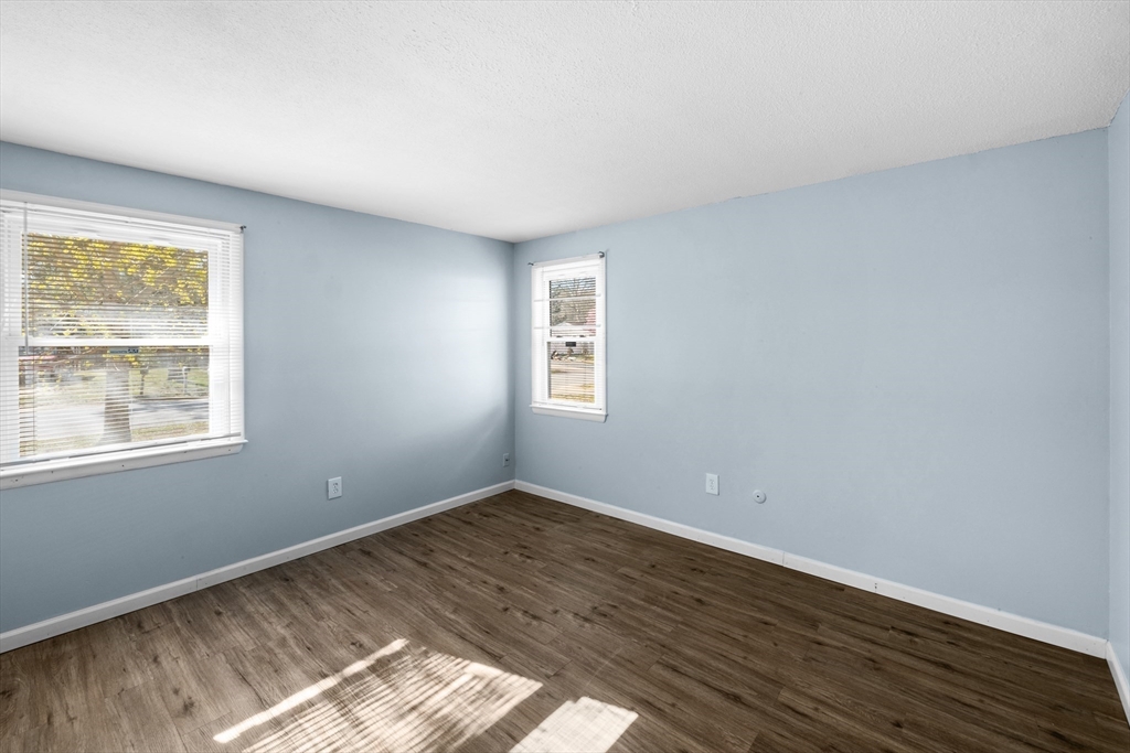 12 Parker Drive Wareham, MA 02571 - Photo 13 of 32 a view of an empty room with wooden floor and a window