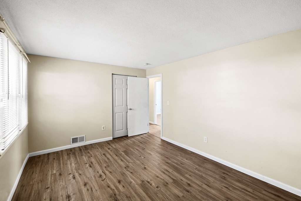 12 Parker Drive Wareham, MA 02571 - Photo 17 of 32 an empty room with wooden floor and windows