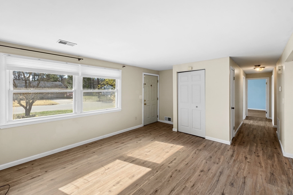 12 Parker Drive Wareham, MA 02571 - Photo 3 of 32 a view of an empty room with wooden floor and a window
