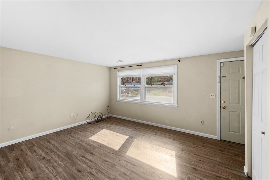 12 Parker Drive Wareham, MA 02571 - Photo 4 of 32 an empty room with wooden floor and windows