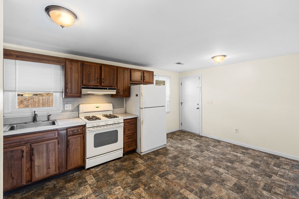 12 Parker Drive Wareham, MA 02571 - Photo 6 of 32 a kitchen with a stove sink and refrigerator