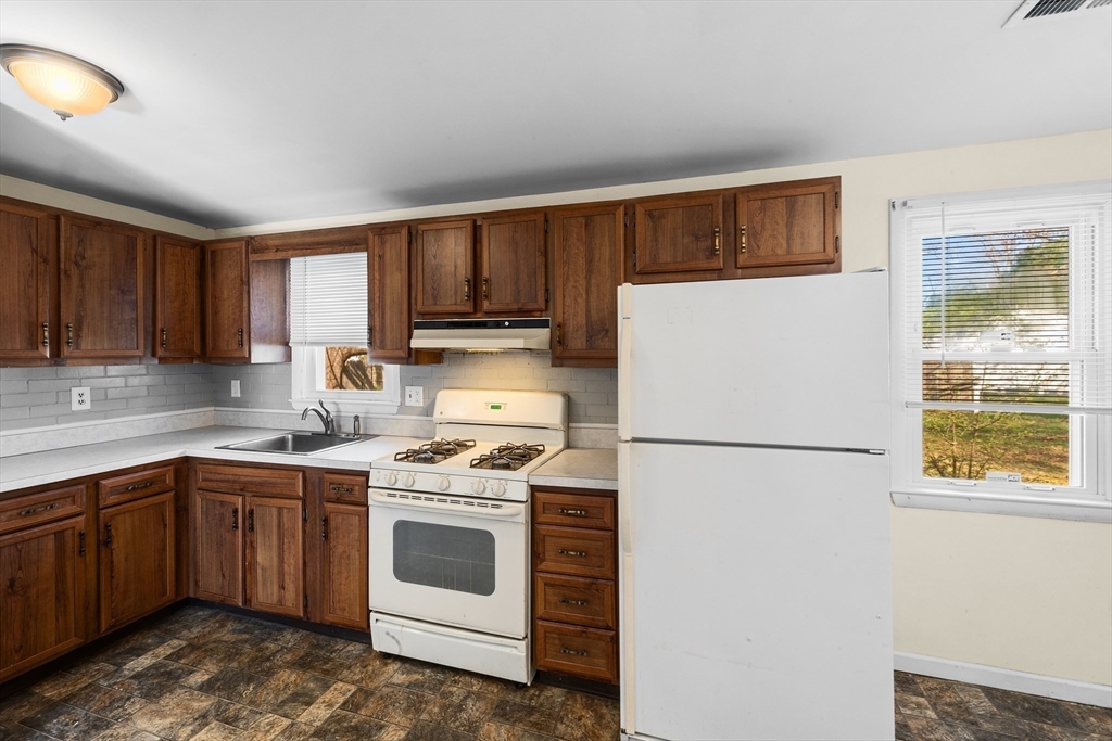 12 Parker Drive Wareham, MA 02571 - Photo 7 of 32 a white refrigerator freezer sitting in a kitchen