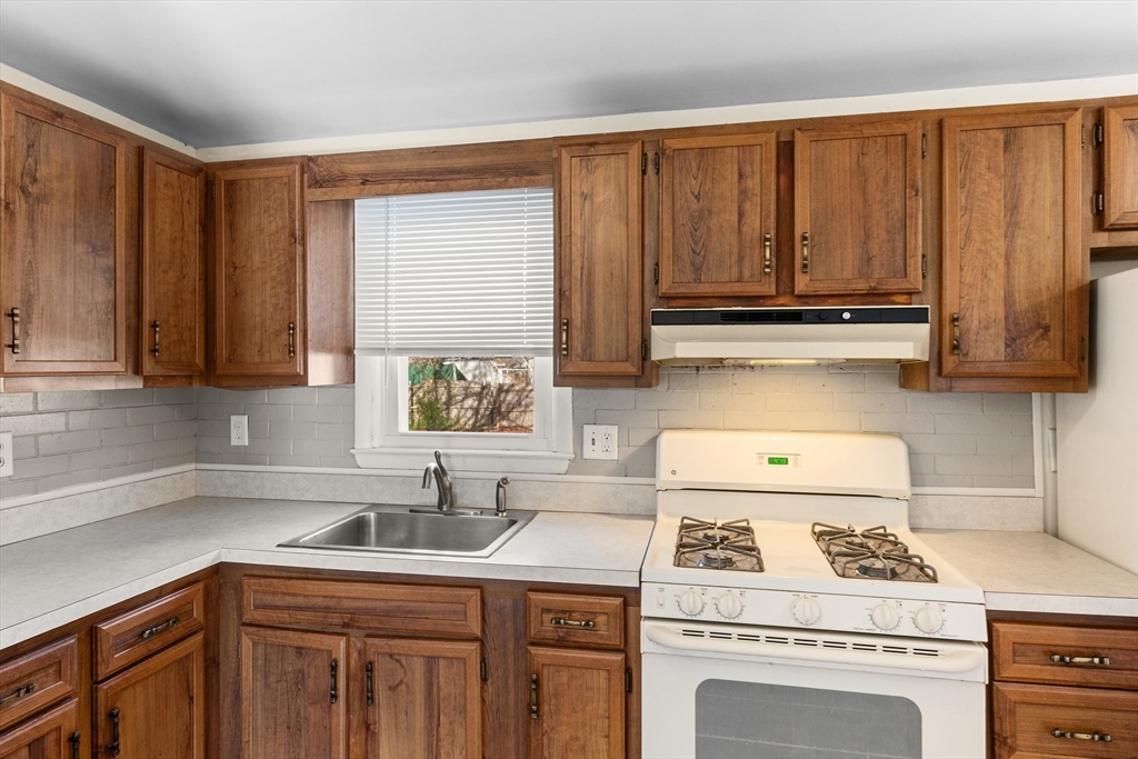 12 Parker Drive Wareham, MA 02571 - Photo 8 of 32 a kitchen with stainless steel appliances granite countertop a sink a stove and cabinets