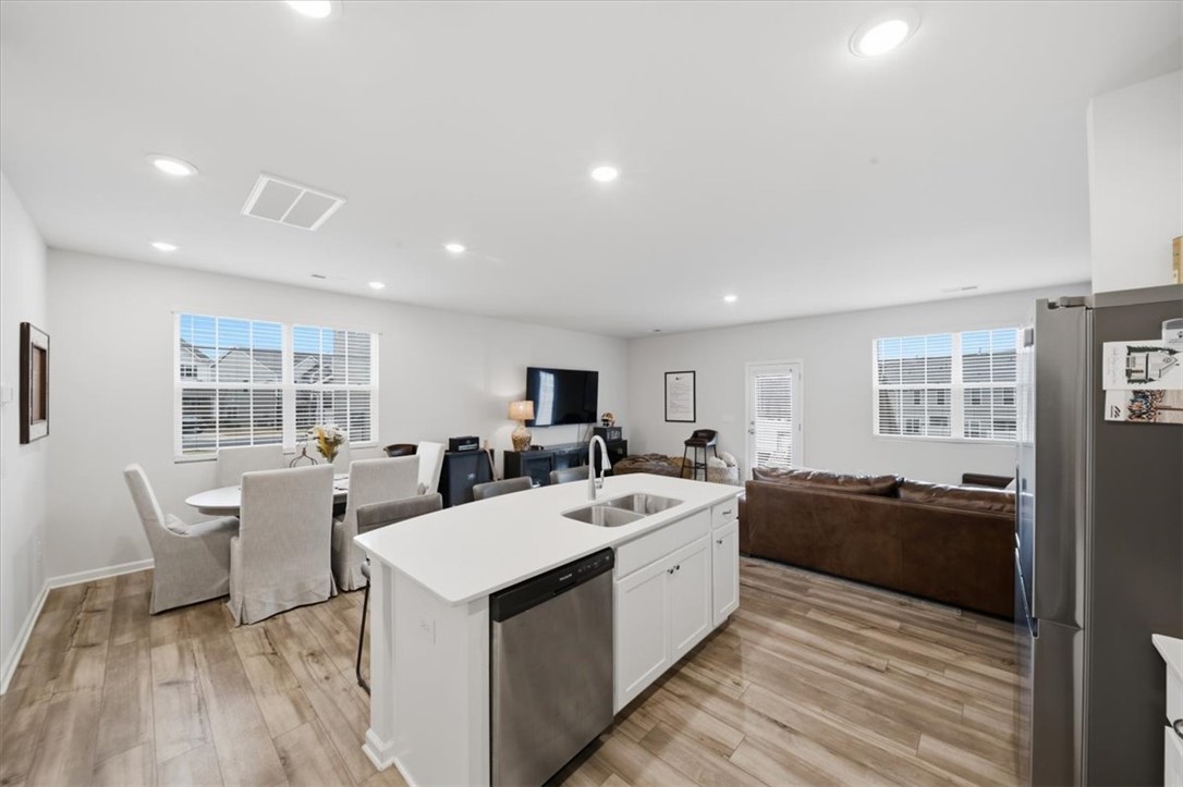 455 Bee Cv Way Pendleton, SC 29670 - Photo 11 of 46 This open concept living area seamlessly blends kitchen, dining, and living spaces.
