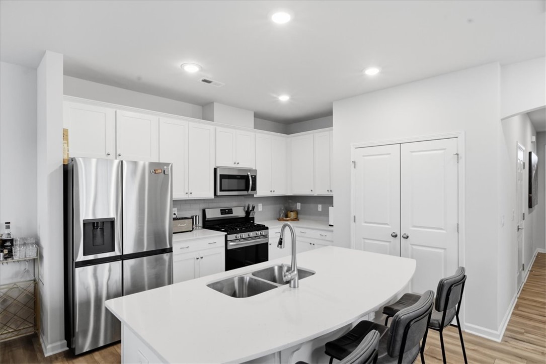 455 Bee Cv Way Pendleton, SC 29670 - Photo 11 of 46 This kitchen features sleek countertops, bright cabinetry, and ample space for culinary endeavors.