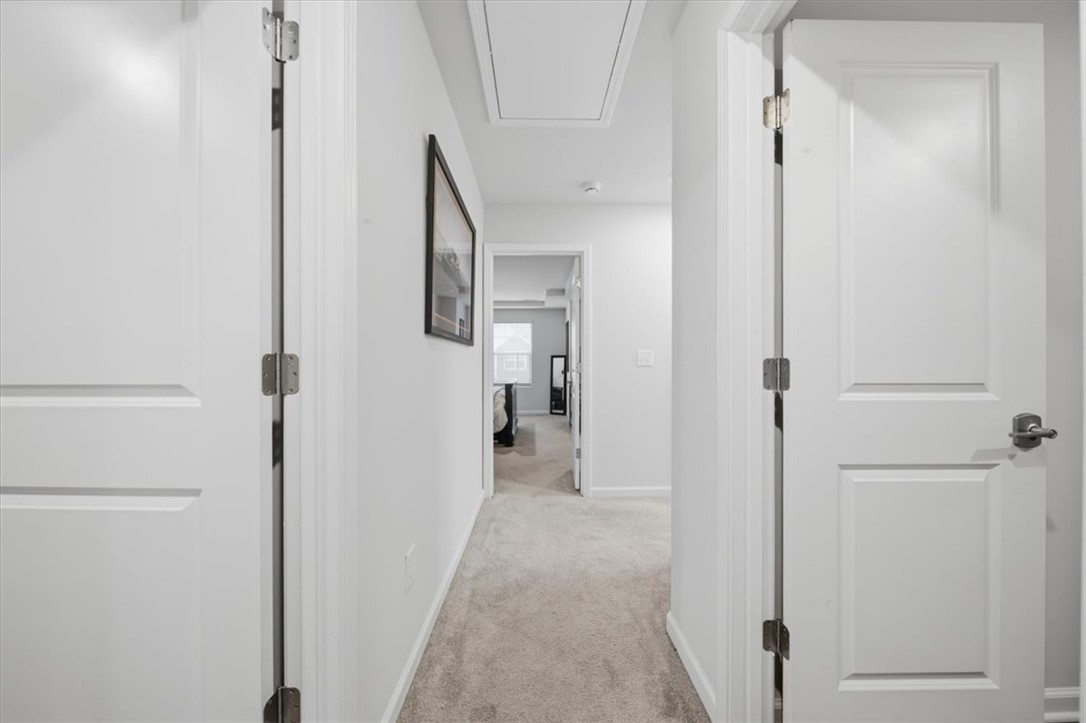455 Bee Cv Way Pendleton, SC 29670 - Photo 27 of 46 This bright hallway connects to various rooms, featuring clean lines and a cozy carpet.