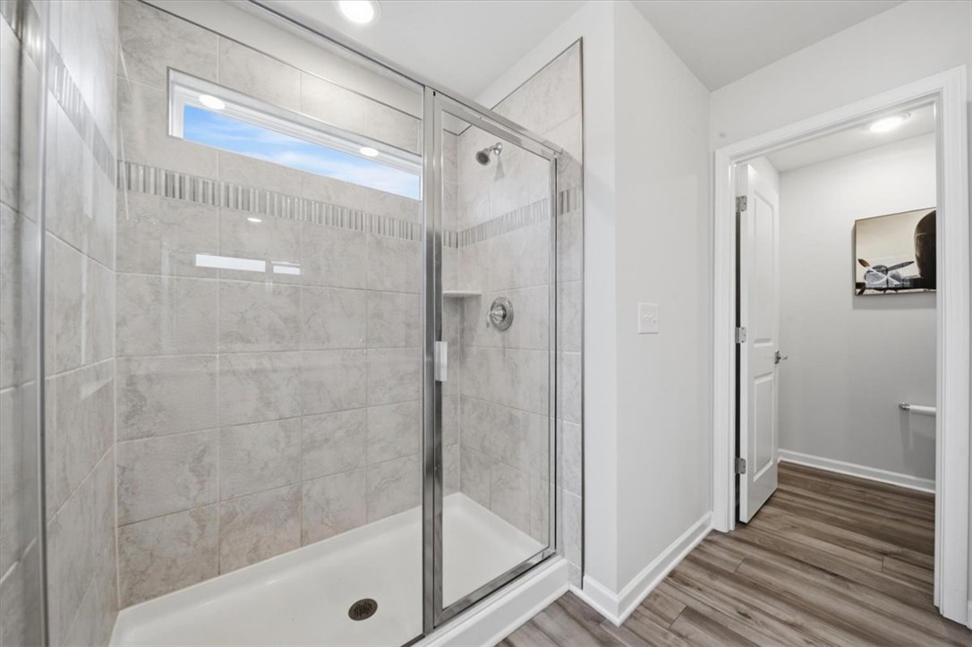 455 Bee Cv Way Pendleton, SC 29670 - Photo 29 of 46 This bright bathroom features a spacious shower with sleek tile, offering a refreshing start to your day.