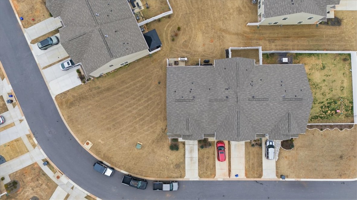455 Bee Cv Way Pendleton, SC 29670 - Photo 33 of 46 This bird's-eye view captures a quiet suburban street with homes and yards.