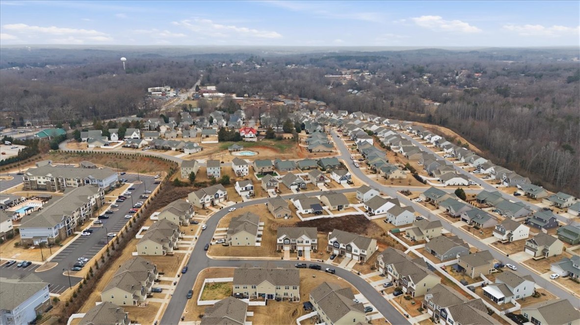 455 Bee Cv Way Pendleton, SC 29670 - Photo 36 of 46 Observe this vibrant community with diverse residential architecture and a serene, natural backdrop.