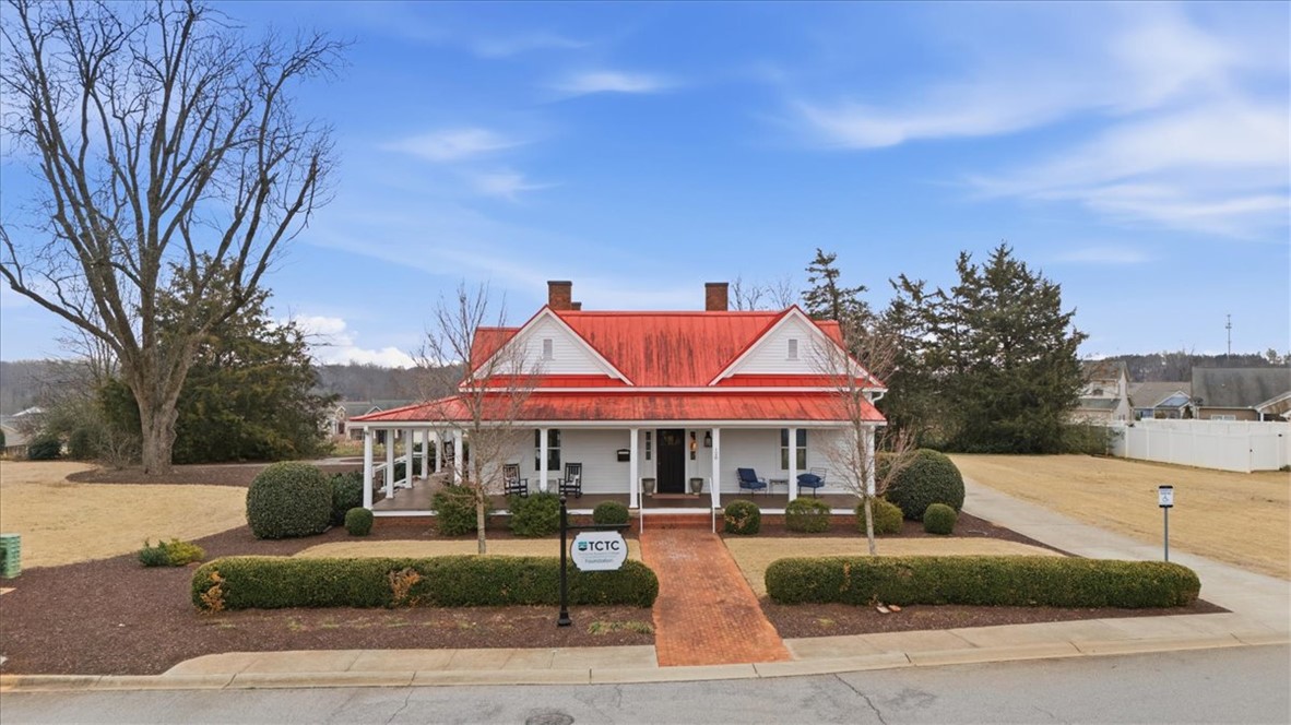 455 Bee Cv Way Pendleton, SC 29670 - Photo 41 of 46 This charming home features a distinctive red roof and a welcoming porch, perfect for enjoying peaceful afternoons.