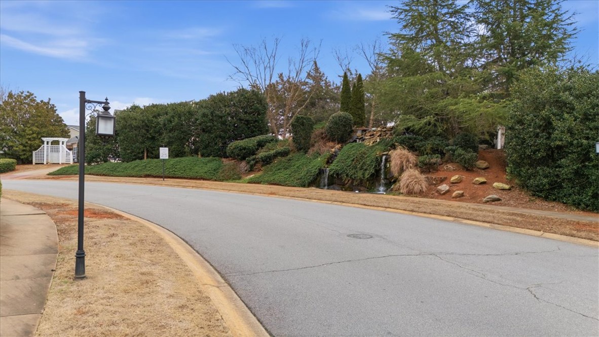455 Bee Cv Way Pendleton, SC 29670 - Photo 42 of 46 This picturesque community entrance features a tranquil waterfall and lush landscaping, welcoming residents home.
