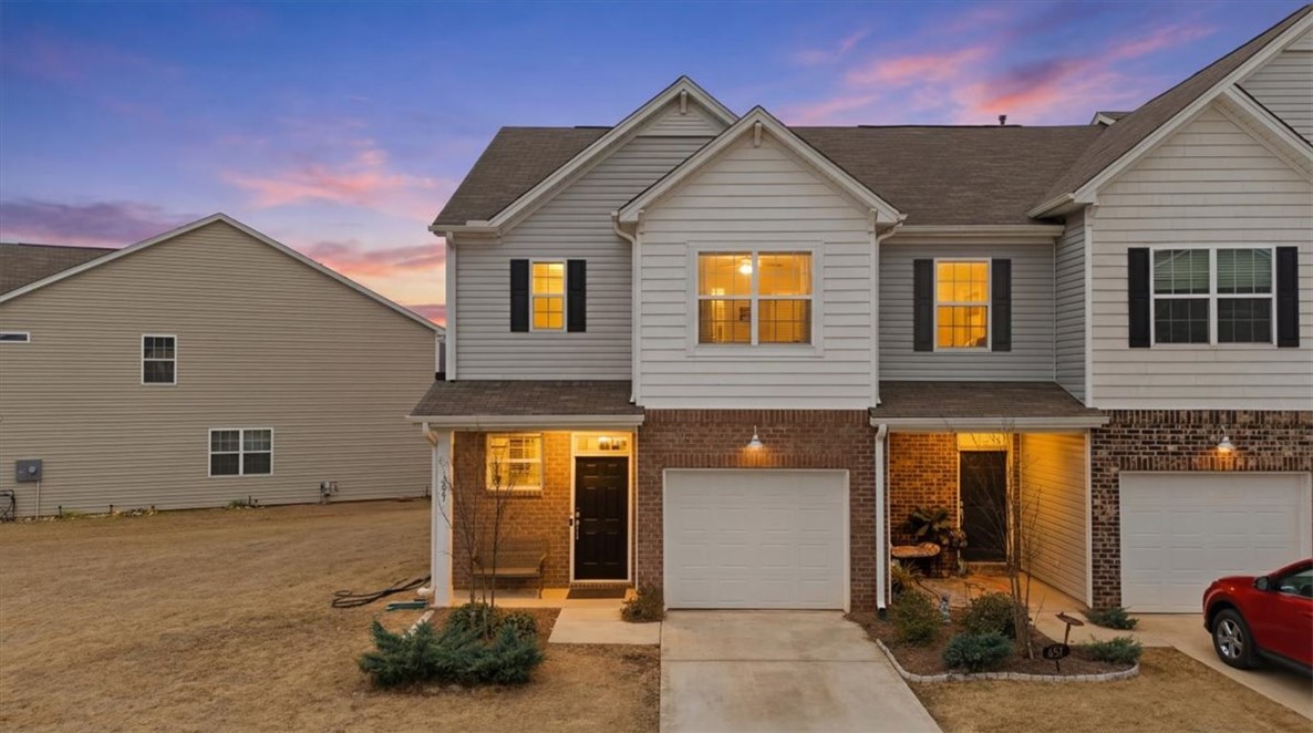 455 Bee Cv Way Pendleton, SC 29670 - Photo 43 of 46 This townhome features a striking facade, combining brick and siding under a classic shingle roof.