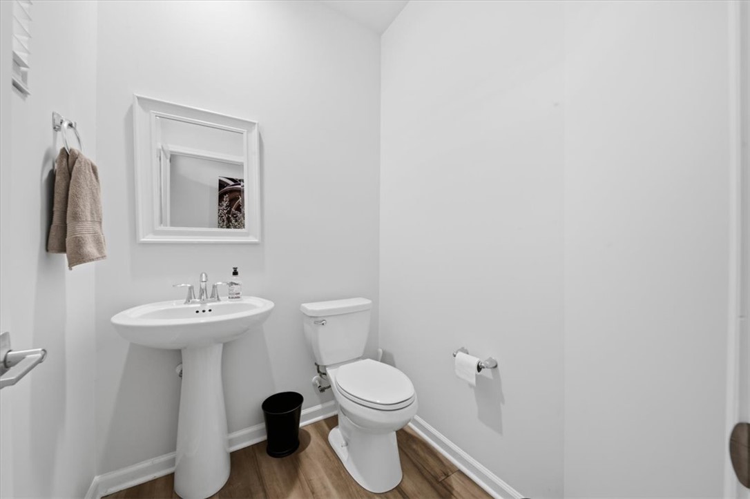 455 Bee Cv Way Pendleton, SC 29670 - Photo 5 of 46 This bathroom features a contemporary pedestal sink and toilet, offering a clean, simple aesthetic.