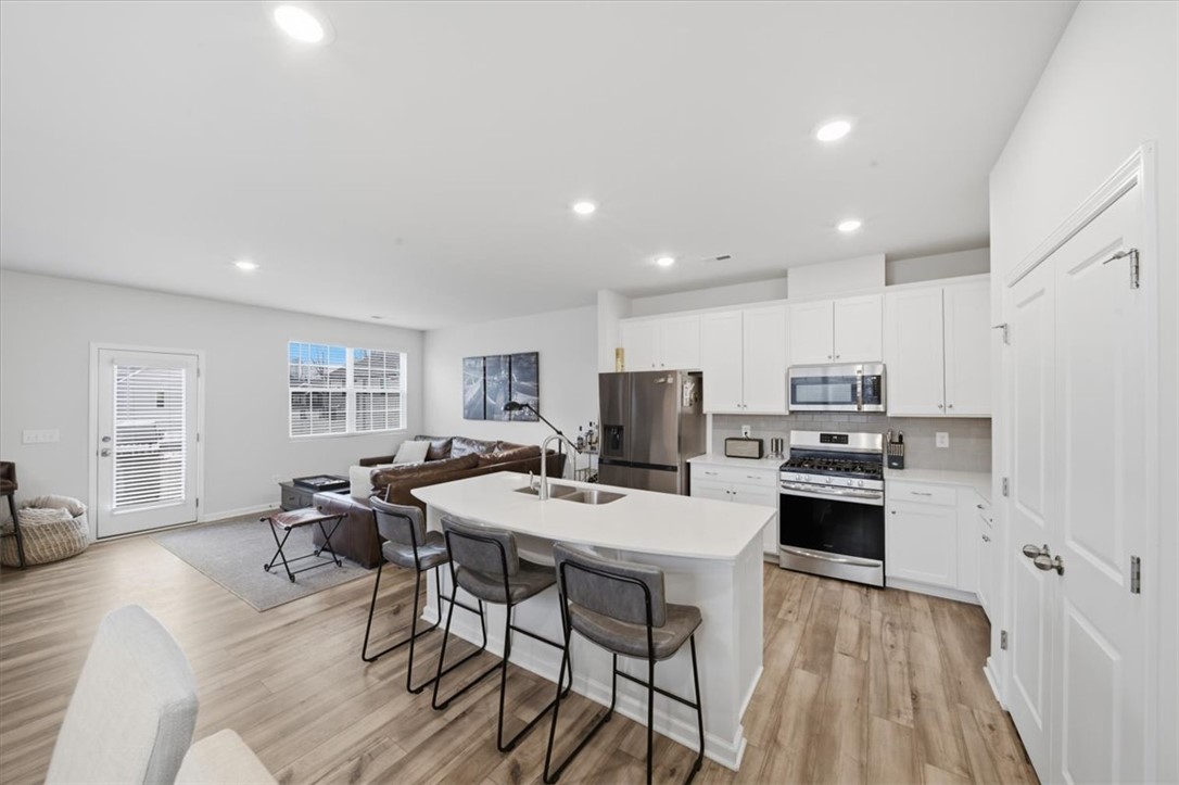 455 Bee Cv Way Pendleton, SC 29670 - Photo 9 of 46 This bright and open space seamlessly connects the kitchen and living areas.