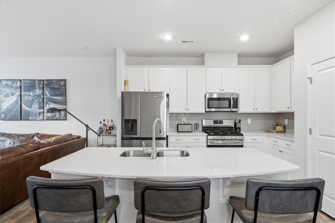 455 Bee Cv Way Pendleton, SC 29670 - Photo 9 of 46 This sleek kitchen features modern appliances and an inviting island, perfect for casual dining and entertaining.