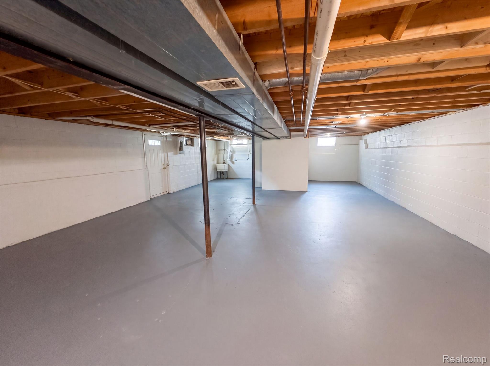 3211 24 Mile Road Utica, MI 48316 - Photo 15 of 18 Spacious unfinished basement featuring painted concrete block walls and a painted concrete floor