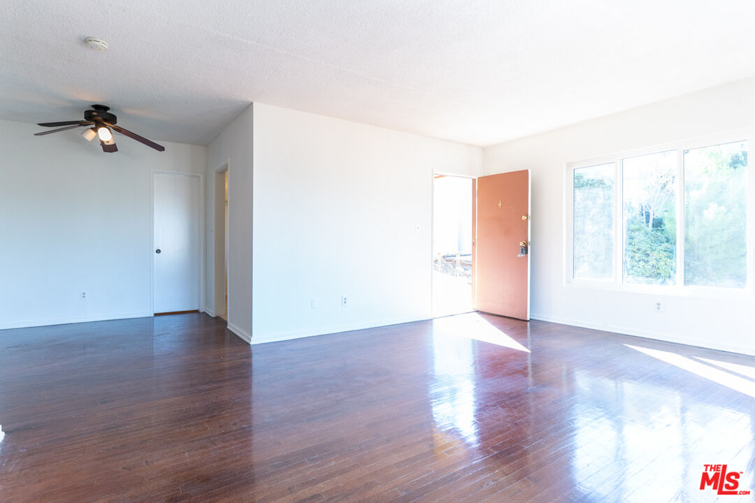 826 Hyperion Avenue Los Angeles, CA 90029 - Photo 14 of 25 an empty room with wooden floor and windows