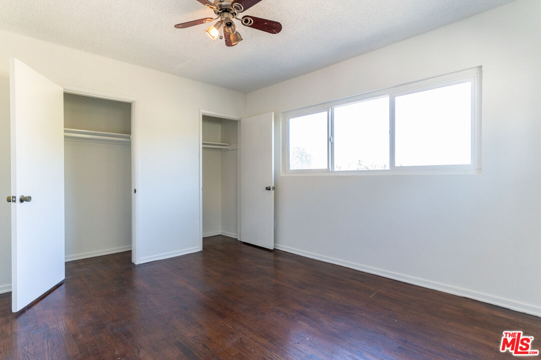 826 Hyperion Avenue Los Angeles, CA 90029 - Photo 20 of 25 a view of an empty room with wooden floor and a window