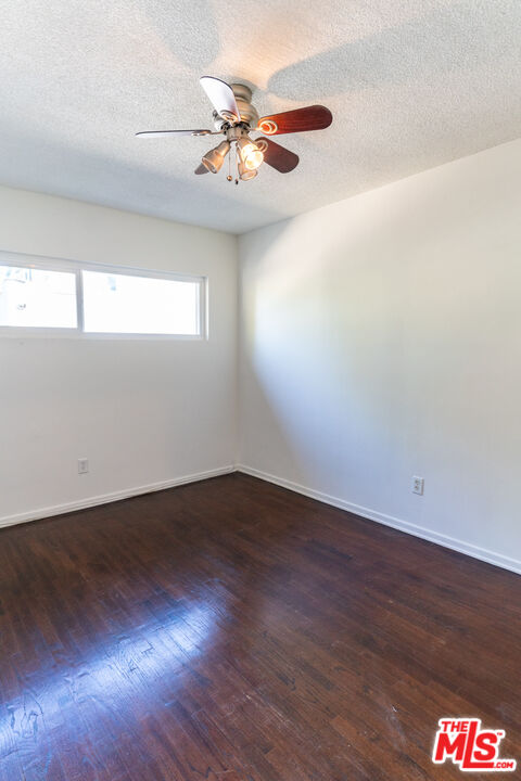 826 Hyperion Avenue Los Angeles, CA 90029 - Photo 23 of 25 an empty room with wooden floor and windows