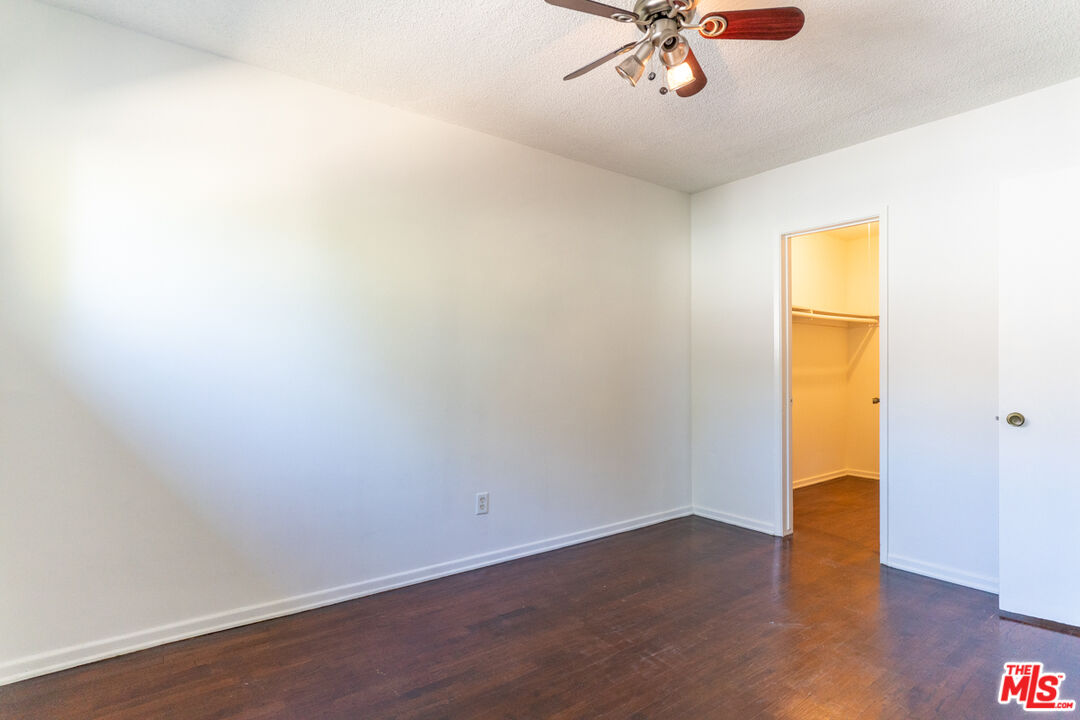 826 Hyperion Avenue Los Angeles, CA 90029 - Photo 24 of 25 a view of a room with wooden floor and a ceiling fan