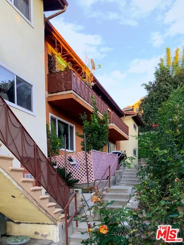 a view of a chairs and table in the balcony