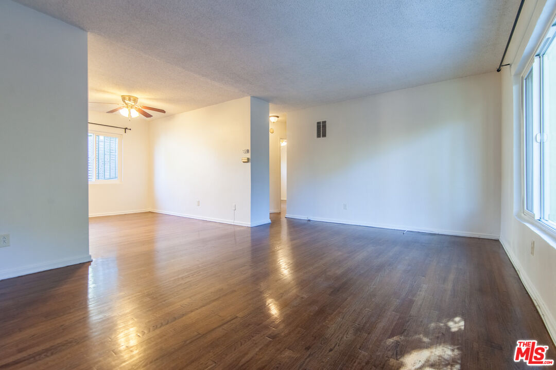 826 Hyperion Avenue Los Angeles, CA 90029 - Photo 5 of 25 a view of a room with wooden floor and a window
