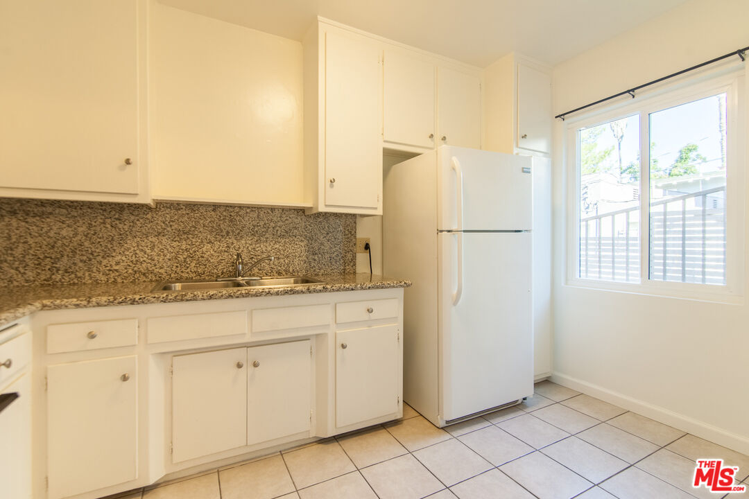 826 Hyperion Avenue Los Angeles, CA 90029 - Photo 7 of 25 a view of a kitchen with white cabinets