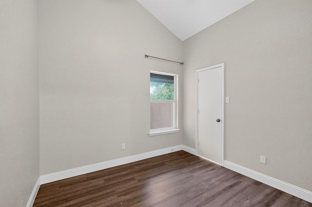 7729 Misty Ridge Drive North Fort Worth, TX 76137 - Photo 18 of 30 a view of an empty room with wooden floor and a window