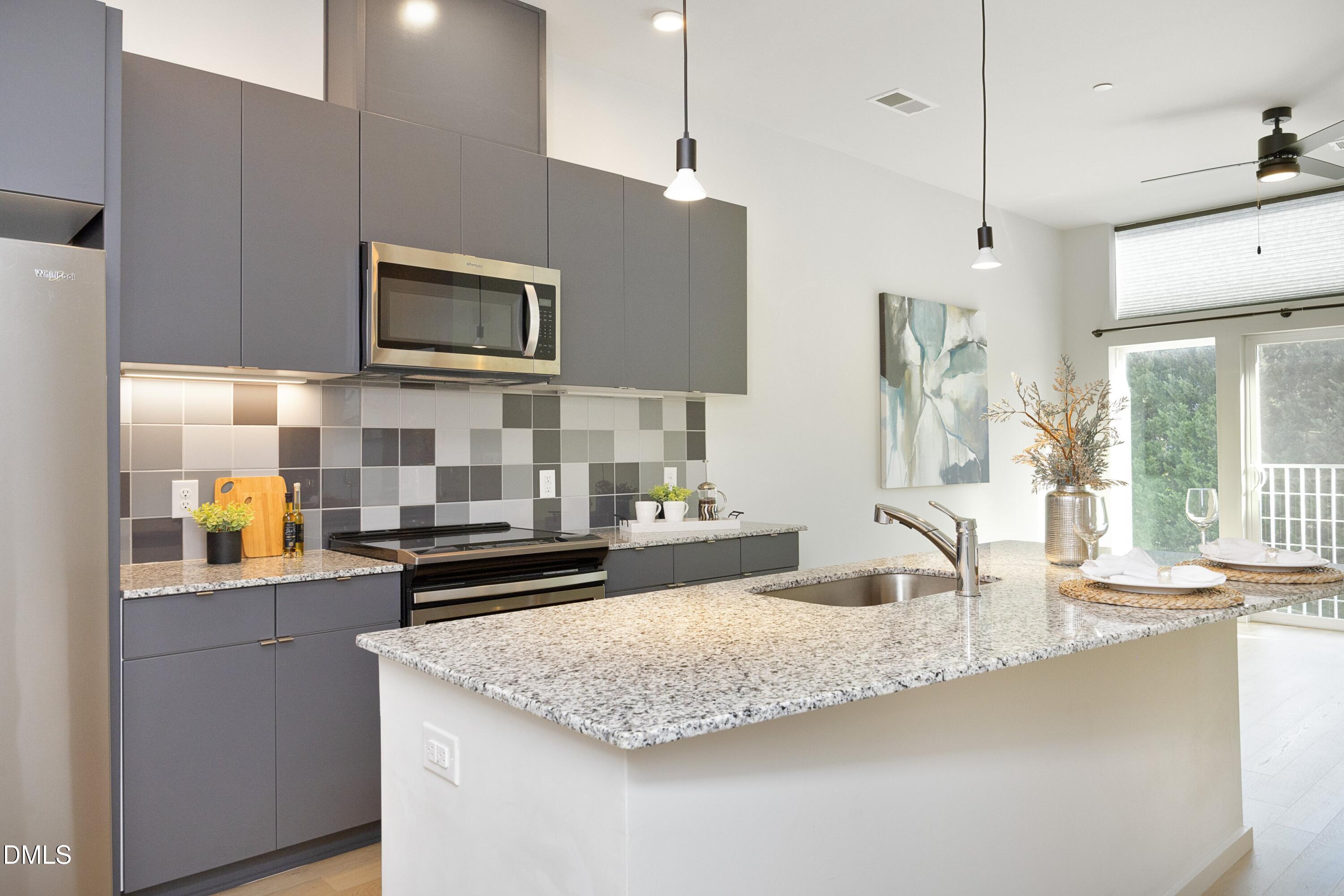 600 South Duke Street, Unit 26 Durham, NC 27701 - Photo 1 of 35 a kitchen with stainless steel appliances granite countertop a sink and a microwave