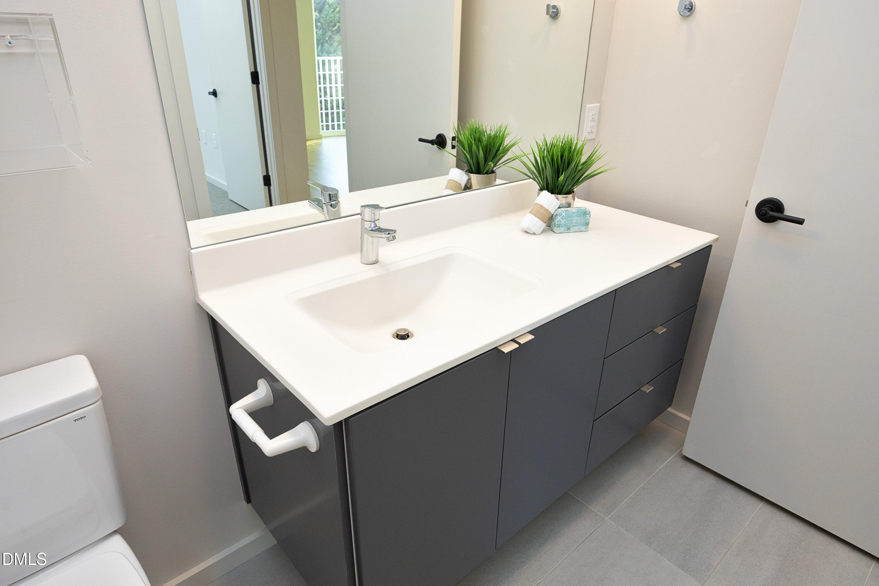 600 South Duke Street, Unit 26 Durham, NC 27701 - Photo 20 of 35 a bathroom with a sink and mirror with toilet