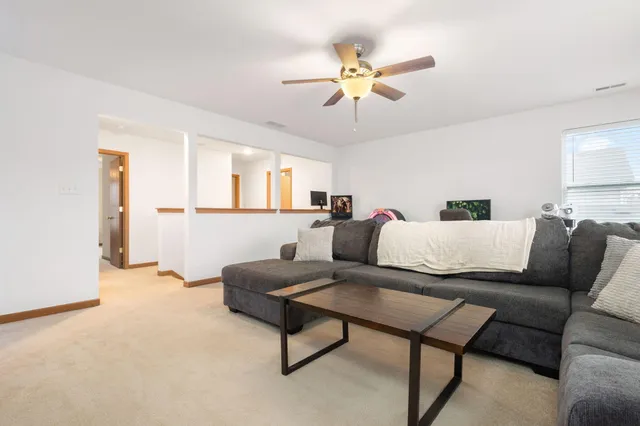 a living room with furniture and a chandelier