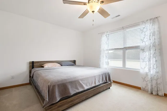 a bedroom with a bed and window