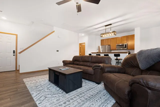 a living room with furniture and a wooden floor
