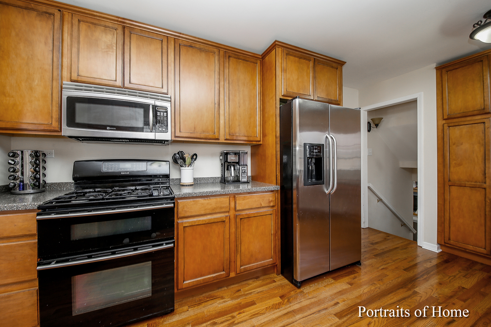 29W150 Smith Road West Chicago, IL 60185 - Photo 11 of 25 a kitchen with granite countertop wooden cabinets stainless steel appliances and a window