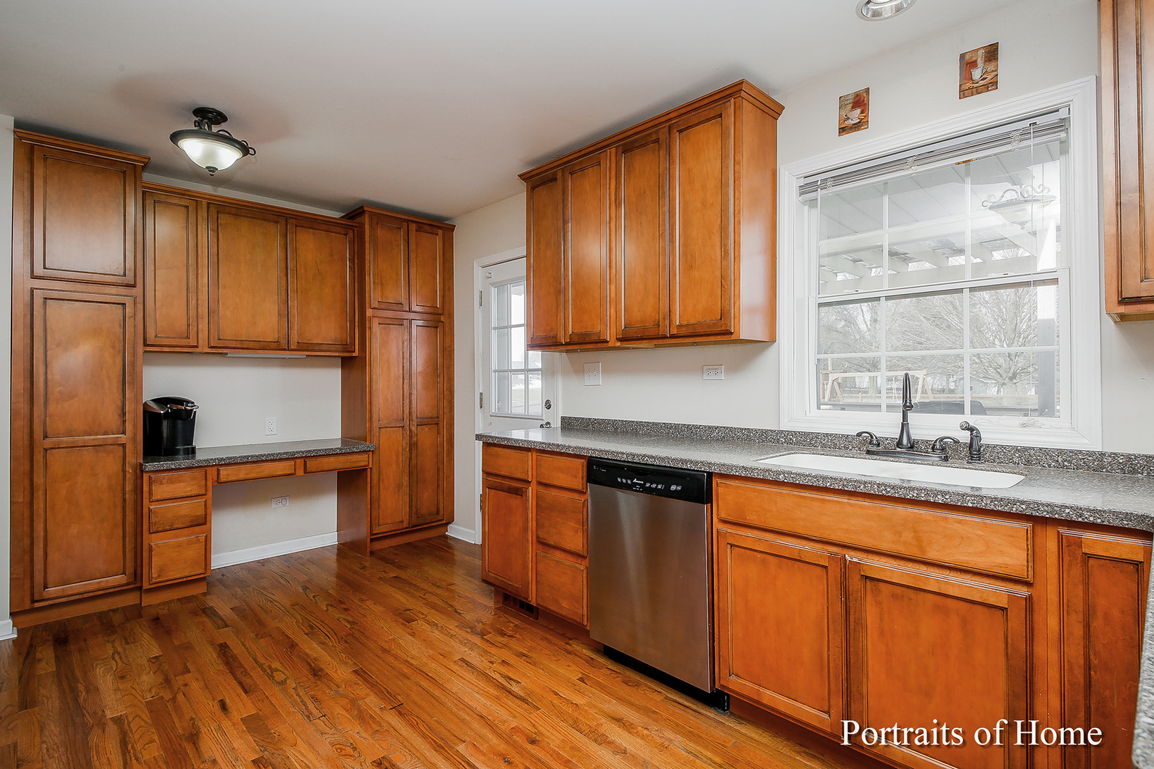 29W150 Smith Road West Chicago, IL 60185 - Photo 12 of 25 a kitchen with stainless steel appliances granite countertop wooden cabinets a sink and dishwasher with wooden floor