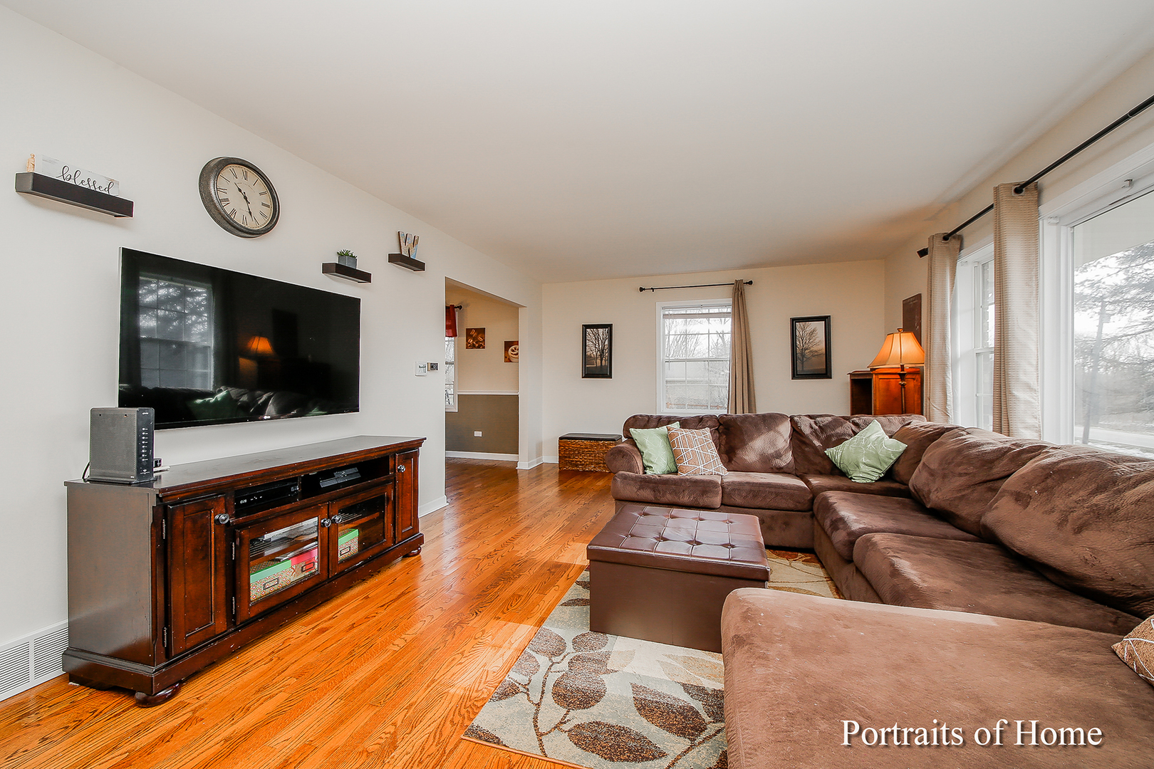 29W150 Smith Road West Chicago, IL 60185 - Photo 6 of 25 a living room with furniture a flat screen tv and a fireplace
