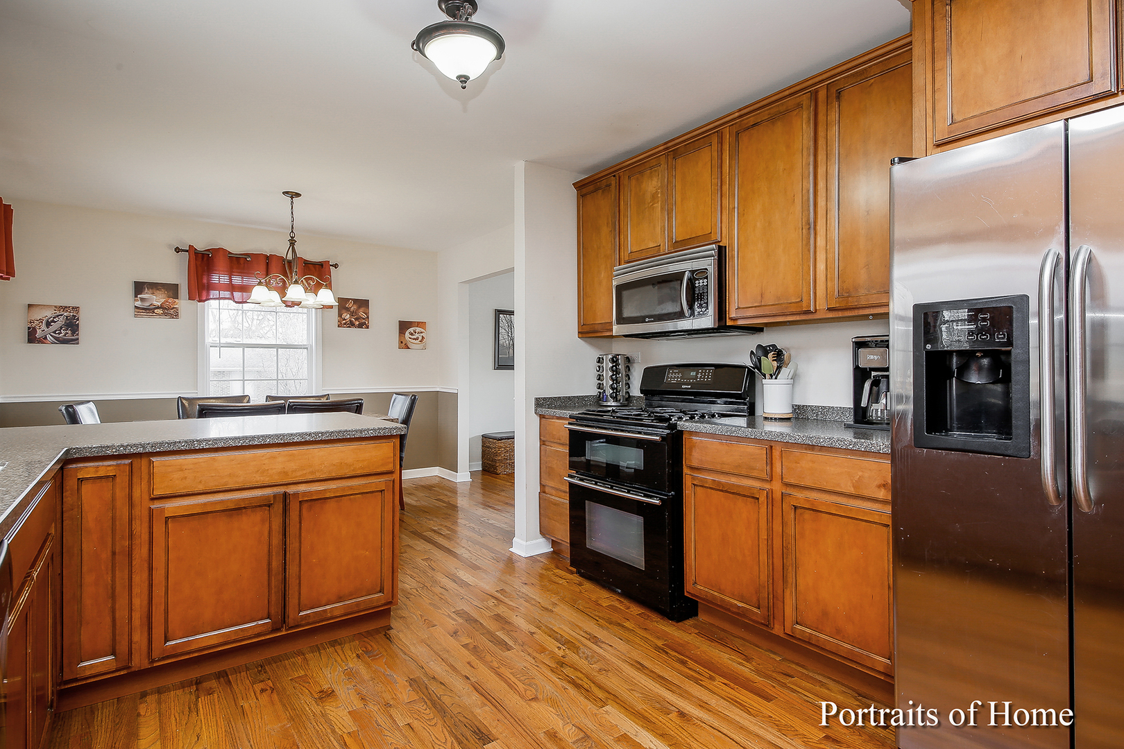 29W150 Smith Road West Chicago, IL 60185 - Photo 10 of 25 a kitchen with stainless steel appliances granite countertop a stove a sink dishwasher and a refrigerator with wooden floor