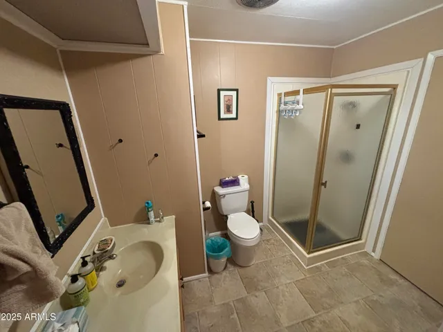 a bathroom with a granite countertop sink toilet and shower
