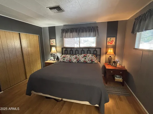 a bed sitting in a room next to a window