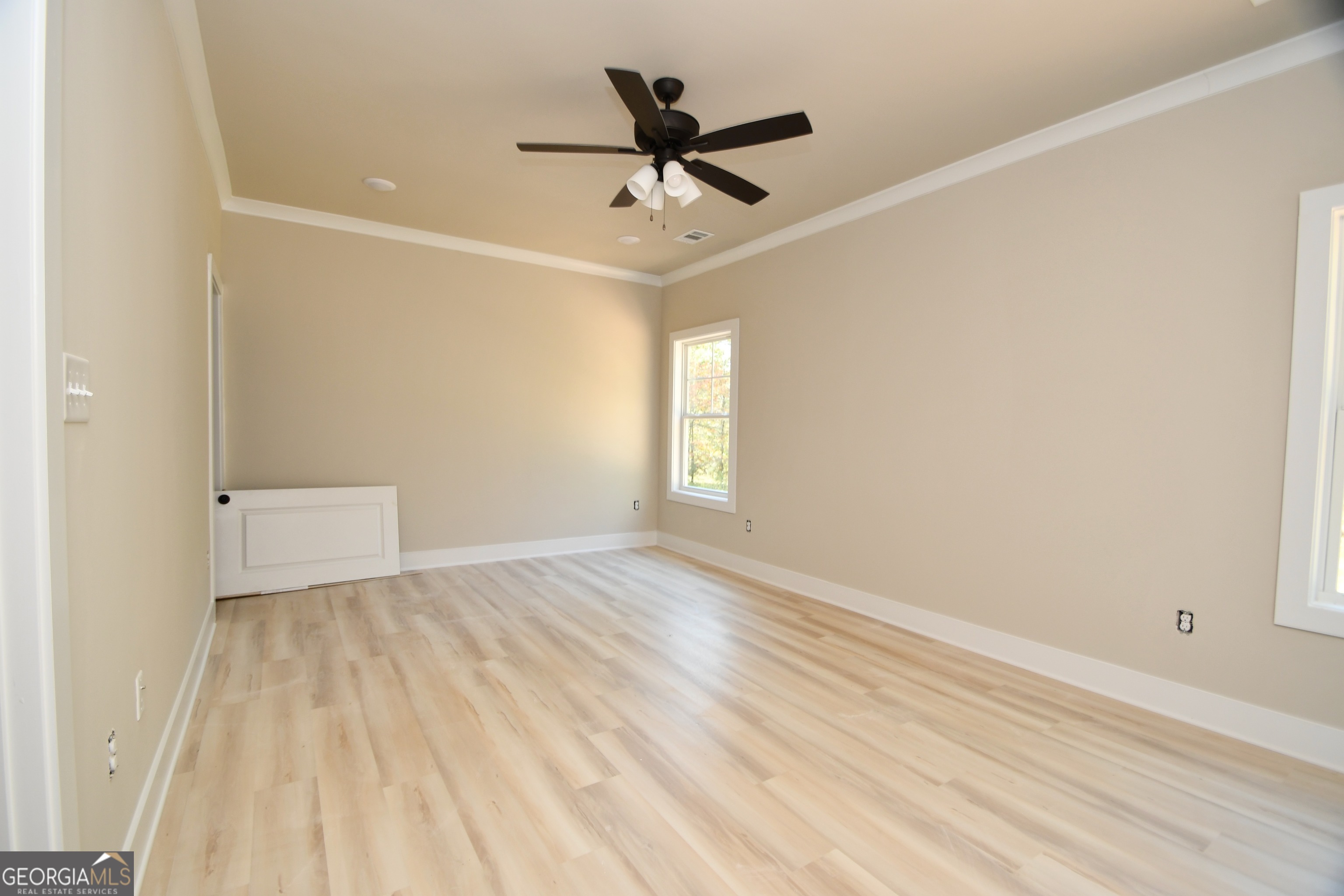 1021 Pointe Street South Tignall, GA 30668 - Photo 12 of 24 wooden floor in an empty room with a window