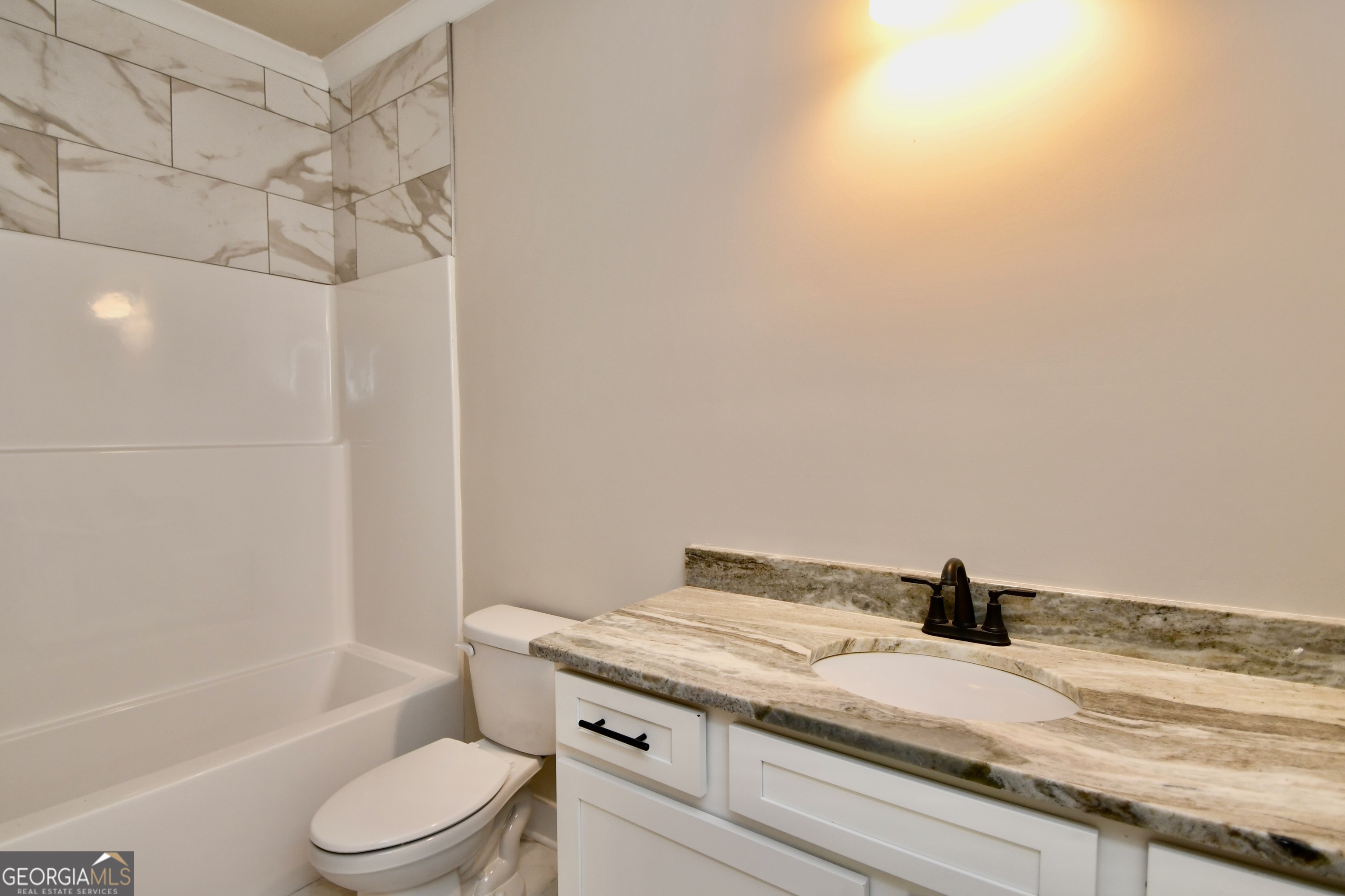 1021 Pointe Street South Tignall, GA 30668 - Photo 13 of 24 a bathroom with a granite countertop sink toilet and bathtub