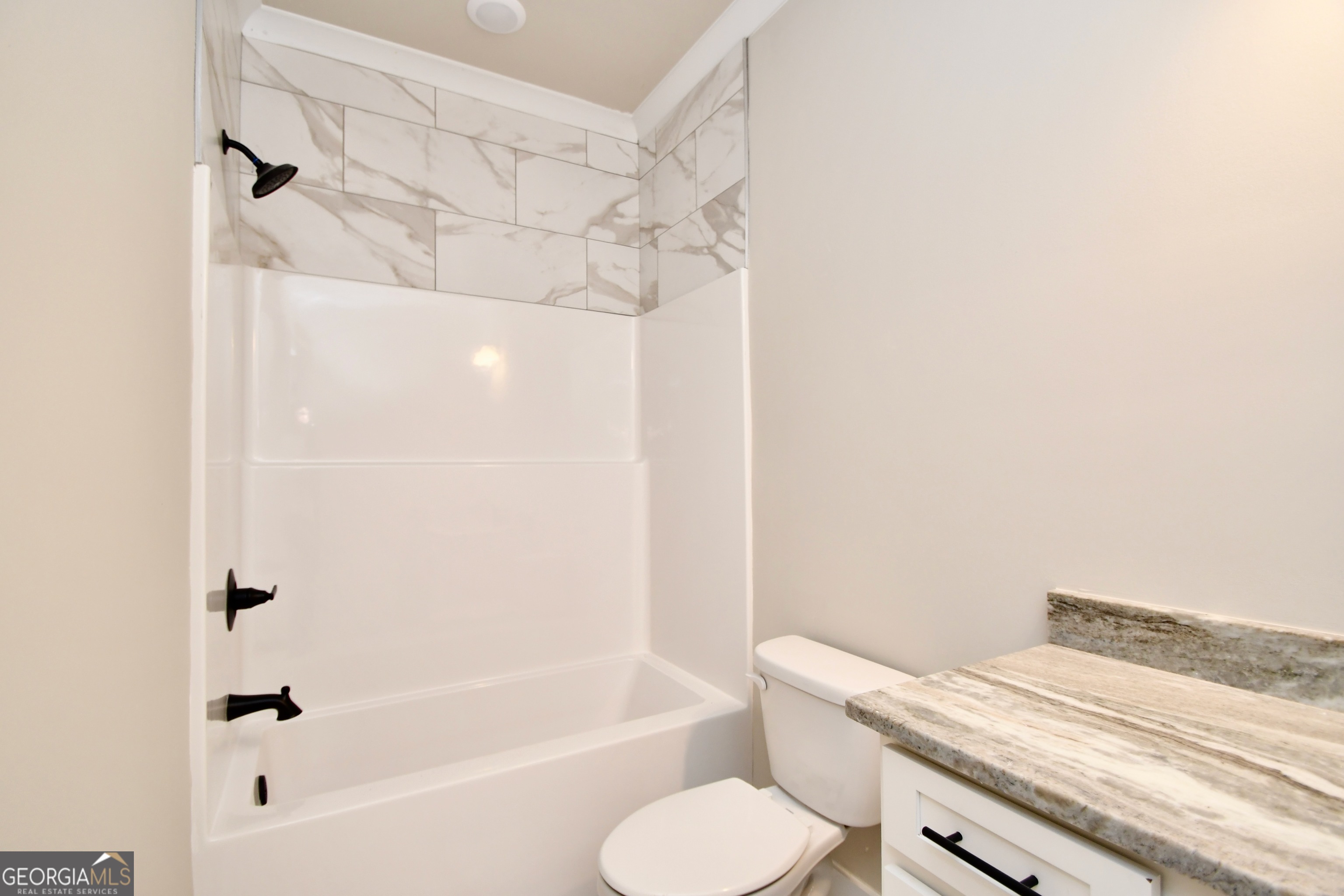 1021 Pointe Street South Tignall, GA 30668 - Photo 14 of 24 a bathroom with a sink a toilet and bathtub