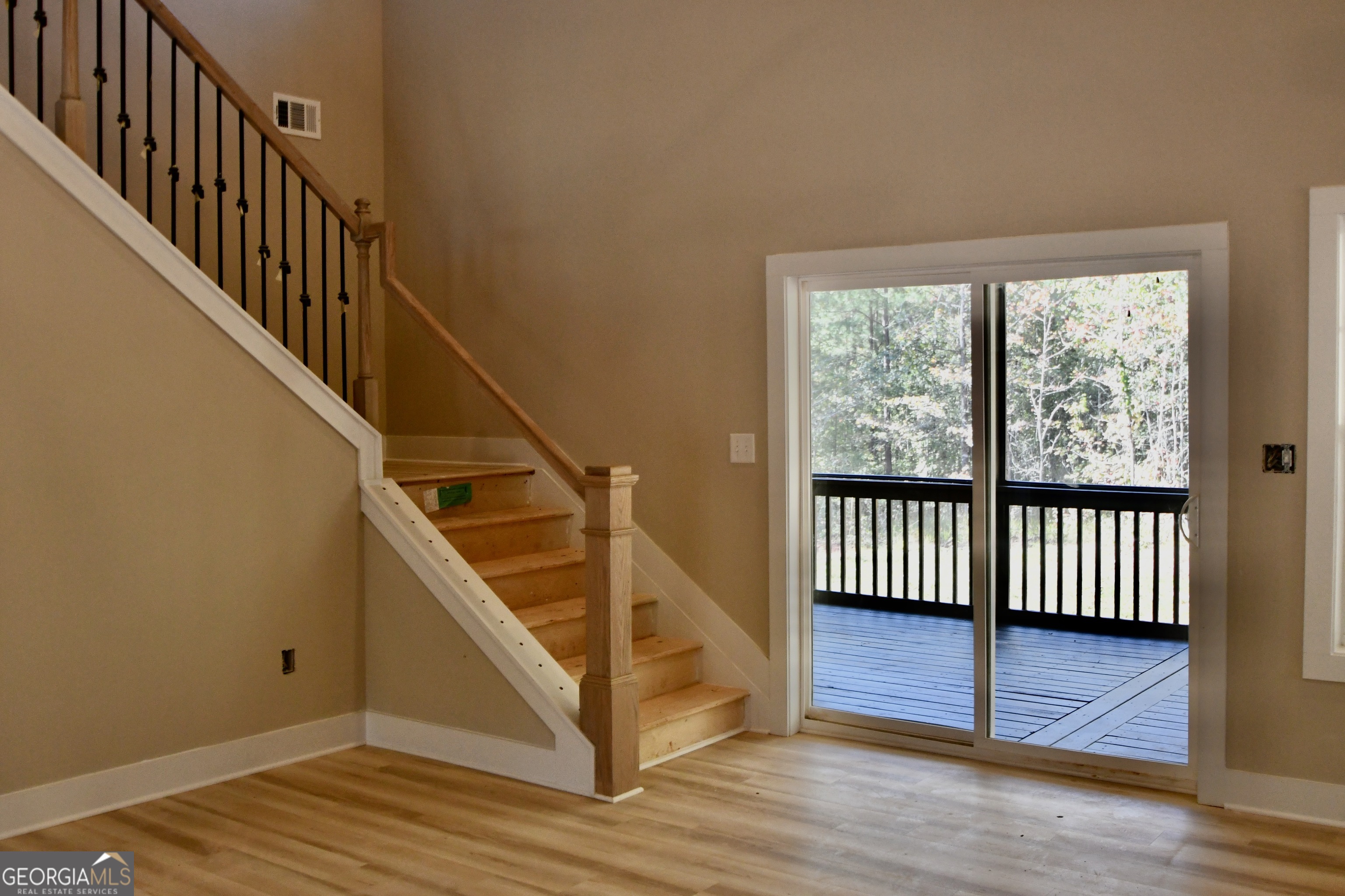 1021 Pointe Street South Tignall, GA 30668 - Photo 5 of 24 a view of entryway with wooden floor and stairs