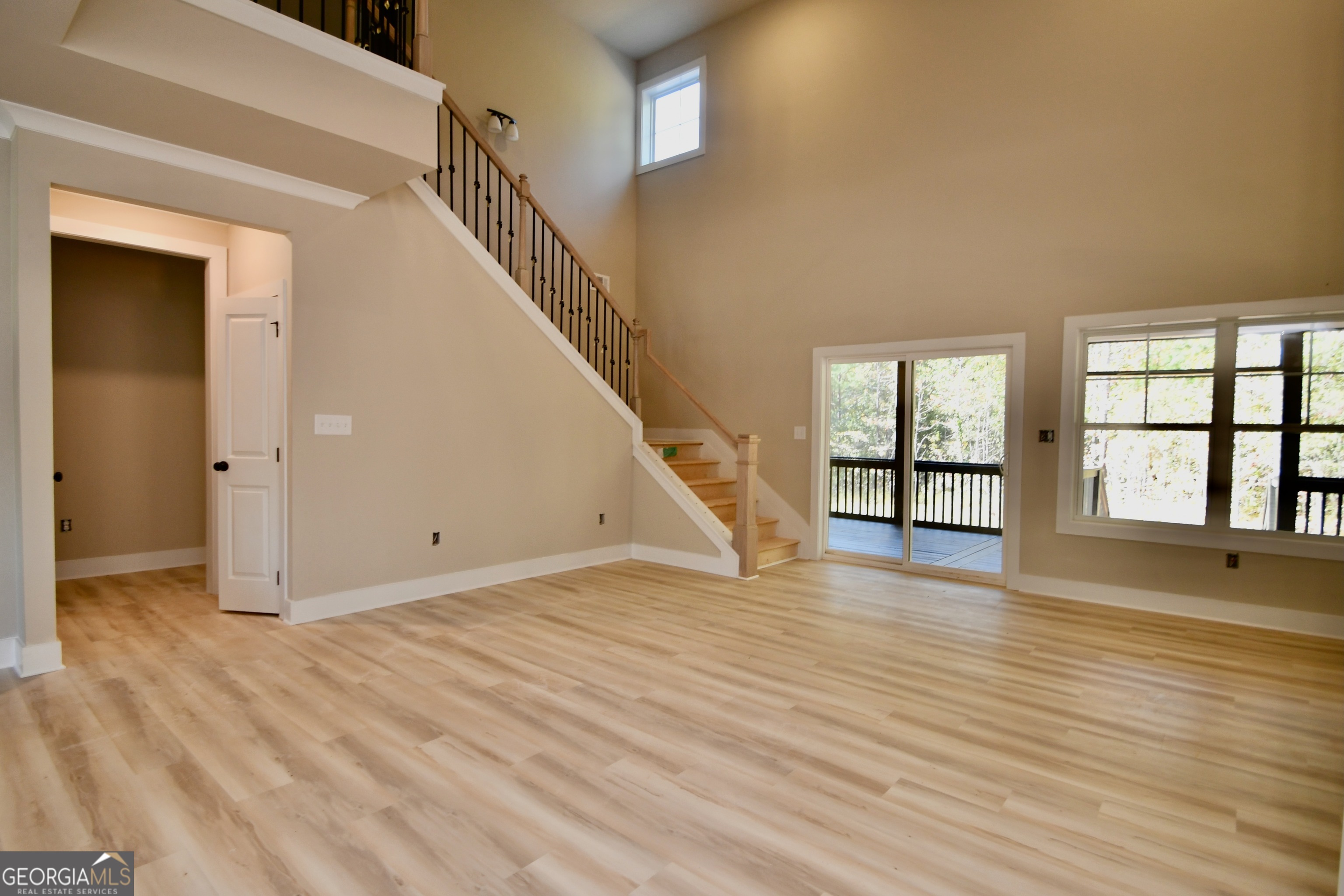 1021 Pointe Street South Tignall, GA 30668 - Photo 7 of 24 a view of an empty room with wooden floor and a window