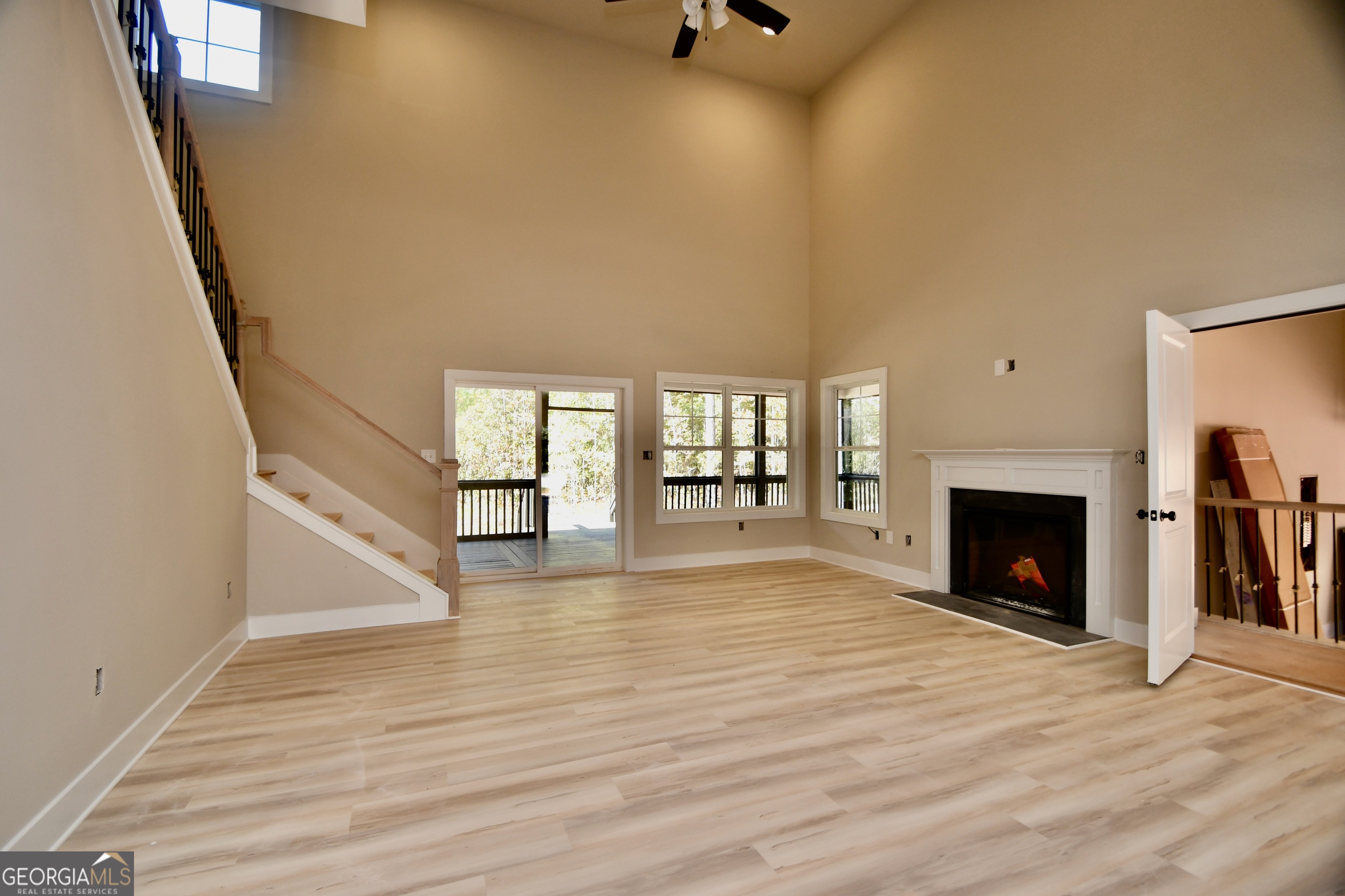 1021 Pointe Street South Tignall, GA 30668 - Photo 9 of 24 a view of an empty room with wooden floor fireplace and a window