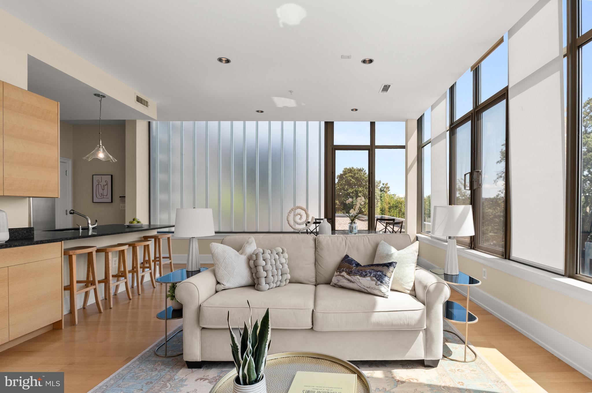 Sun-filled living space w/wall of windows